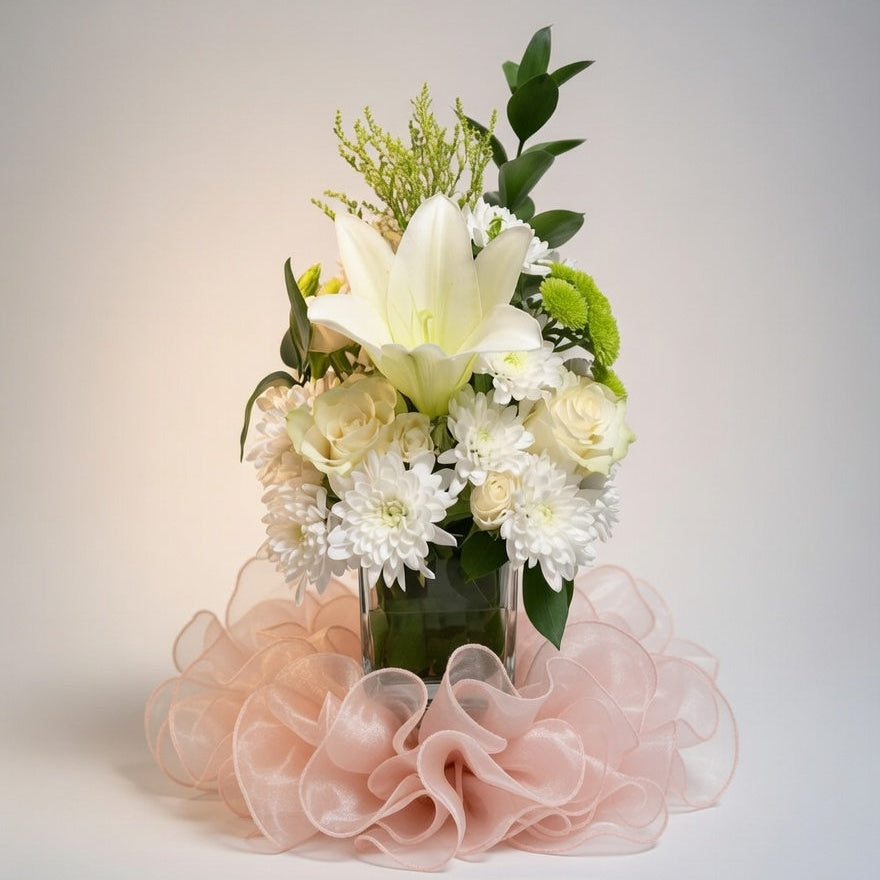 Bouquet of flowers with a pink ruffled base on a light gray background