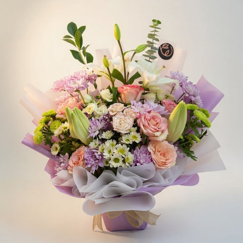 Bouquet of flowers with pink, white, and green colors on a light background