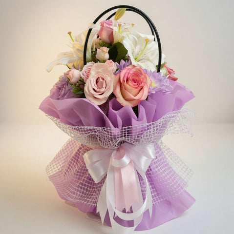 Bouquet of flowers with a black basket on a light background