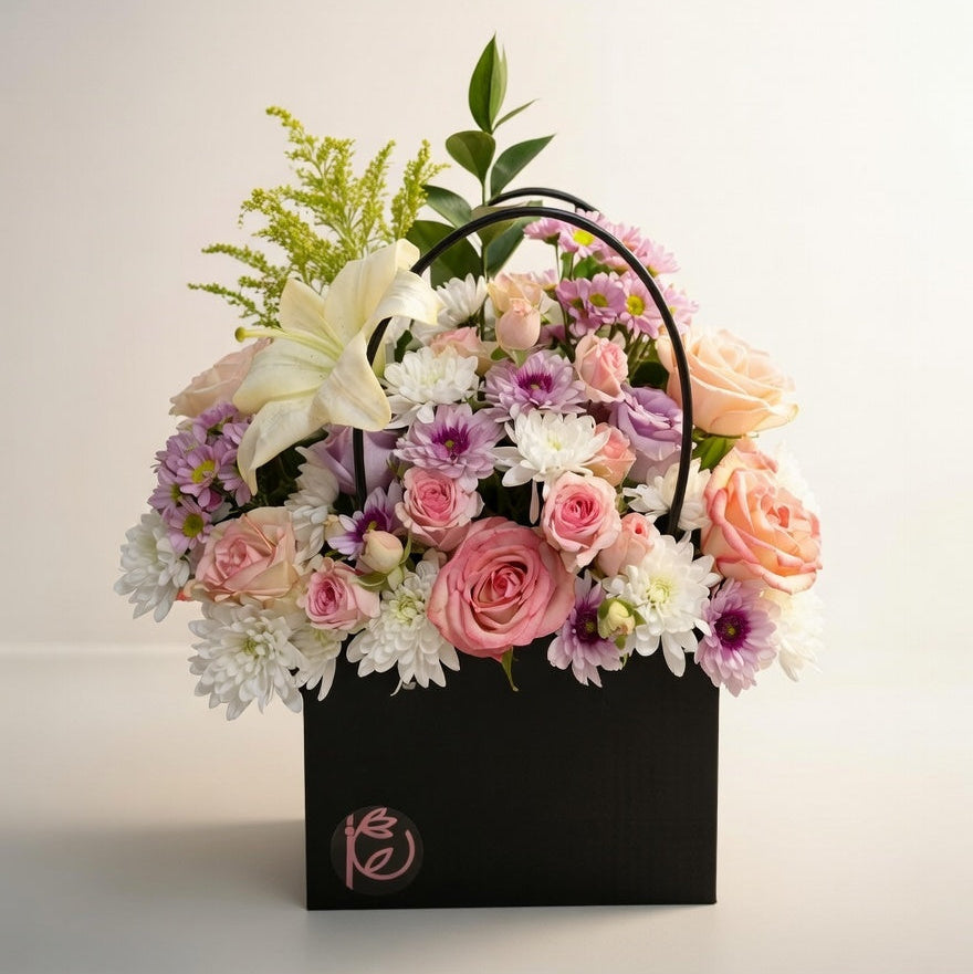 Floral arrangement in a black box with a soft light background