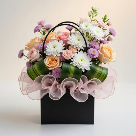 Floral arrangement in a watering can with pink and white flowers on a light background