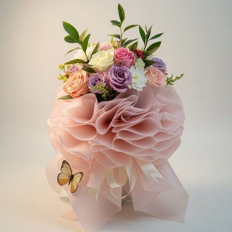 Bouquet of flowers with a pink ribbon and butterfly on a light background