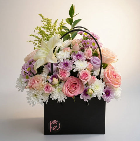 Floral arrangement in a black box with a soft background